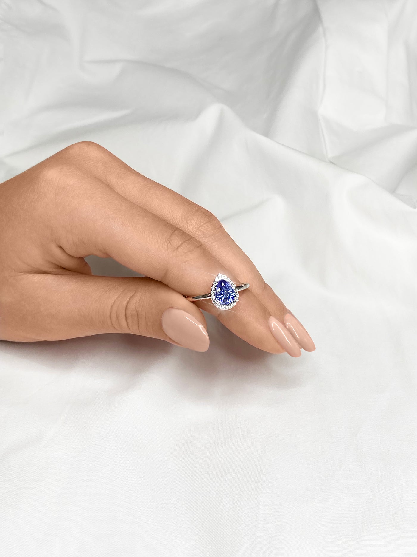 18ct pear shaped ceylon sapphire and diamond ring on hand