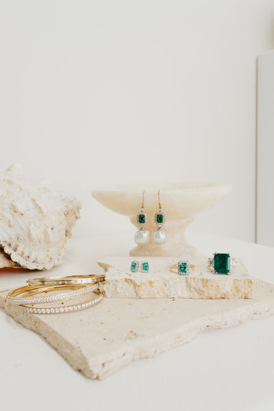 bangles, earings, and rings on a stone 
