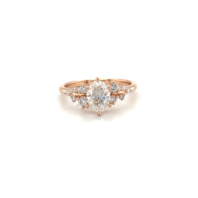 9ct rose gold and eco diamond engagement ring featuring a 1.0ct oval centre and .20ct round brilliant cut accent diamonds