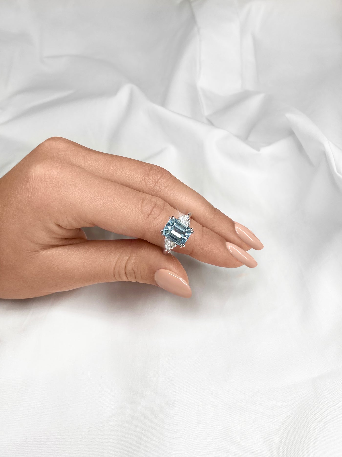 18ct WG 3.10ct Emerald cut aquamarine ring on finger
