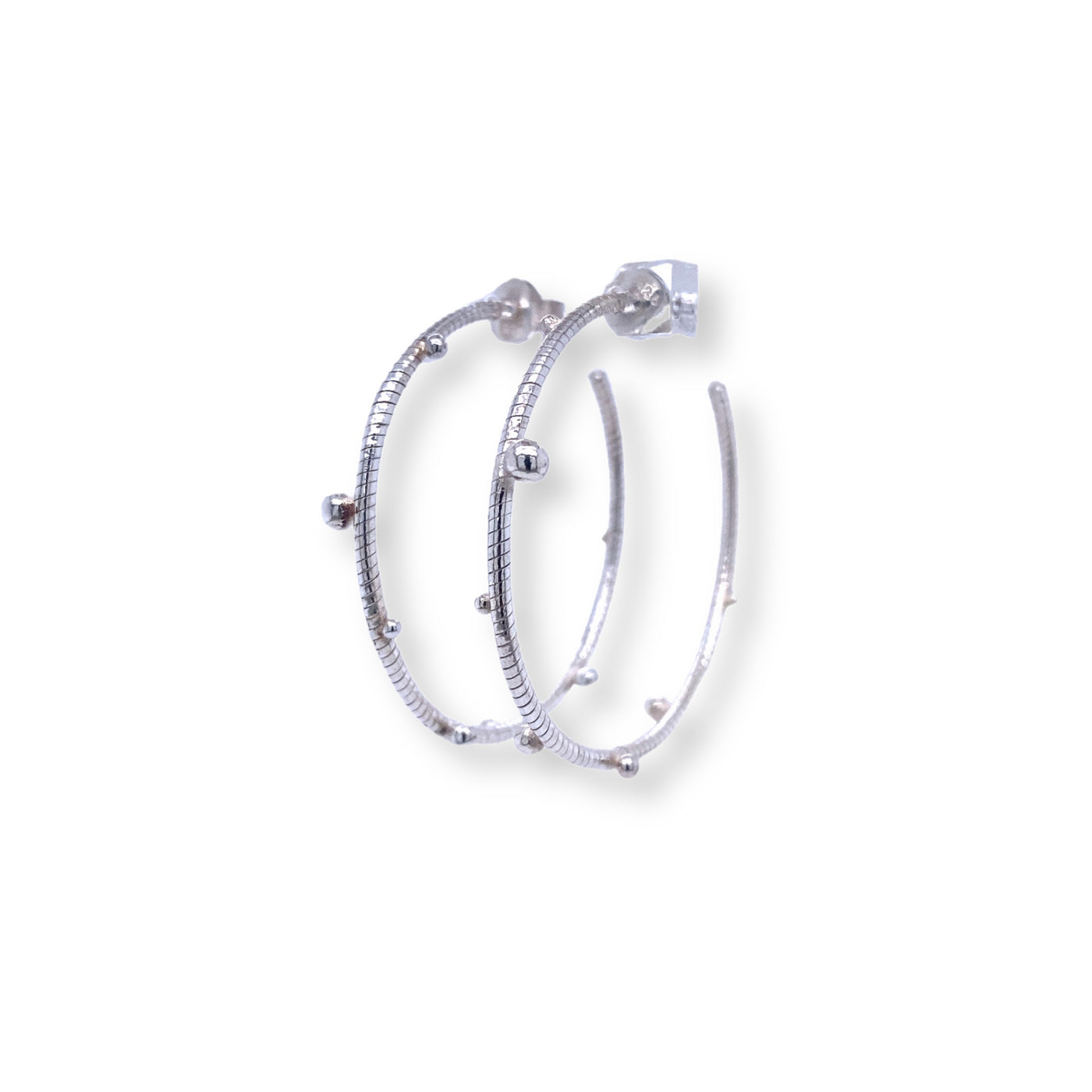 Sterling silver textured hoops featuring silver dots
